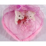 Valentine Couple Teddy Bears sitting on a pink plush heart covered with net